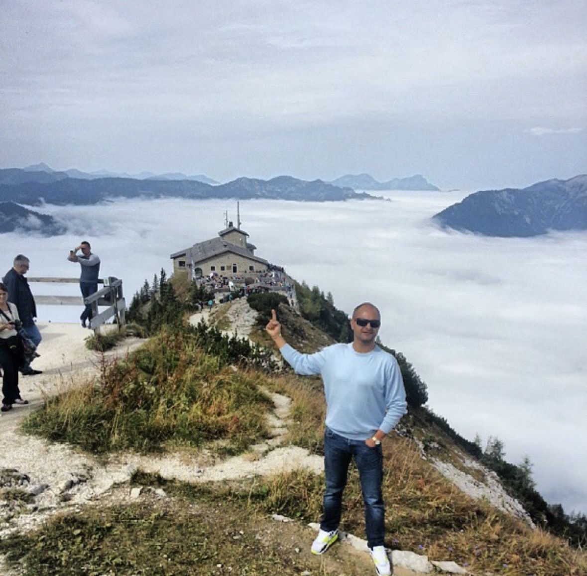 Visitors enjoying Bavarian food and beer on the Eagle's Nest summit terrace with Alpine views